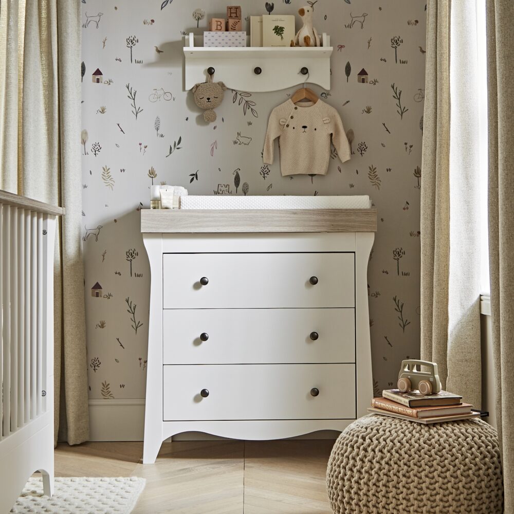 CuddleCo Clara Dresser/Changer -White & Ash With a removable top and floral wallpaper